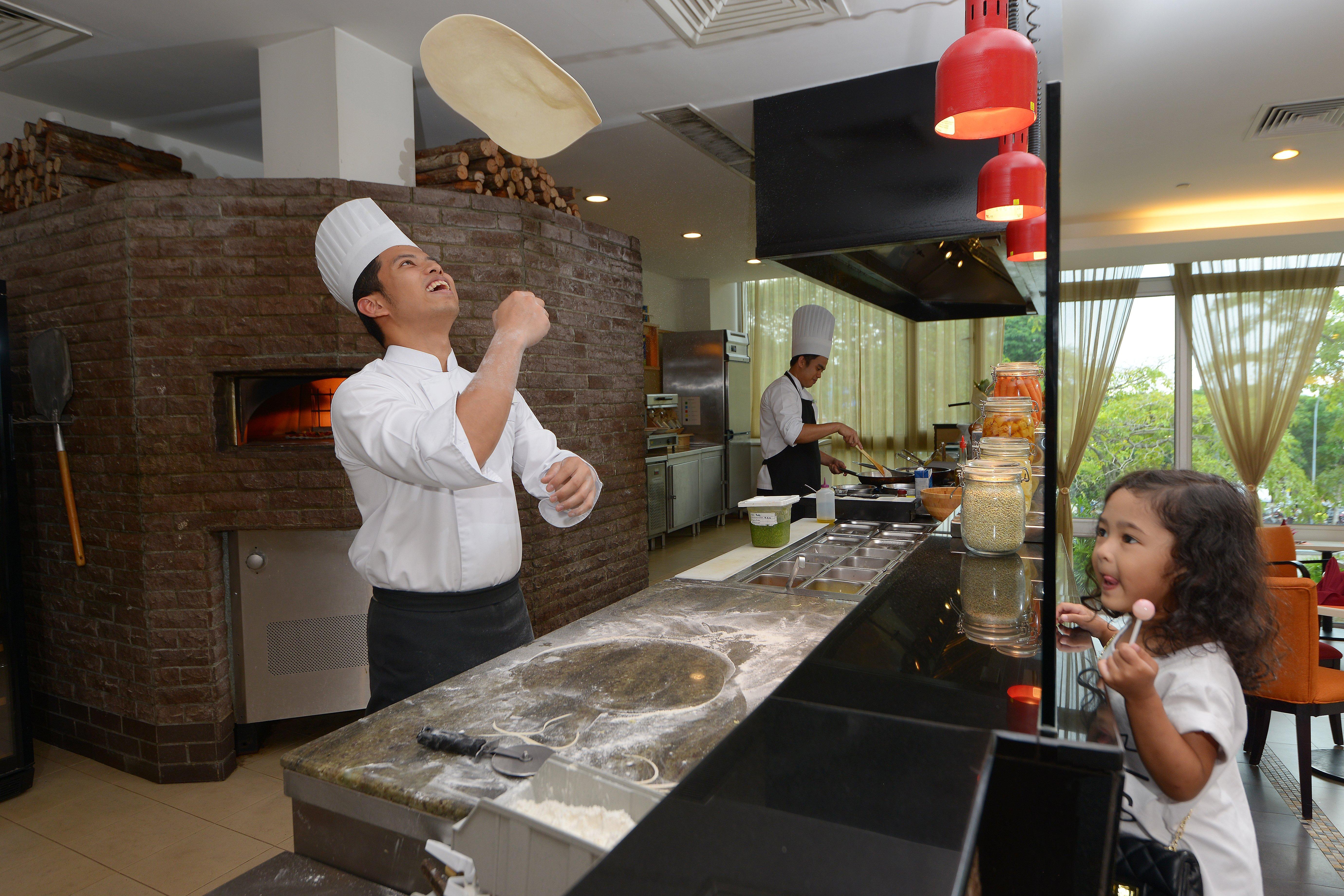 Holiday Inn Melaka By Ihg Exterior photo Chef throwing pizza dough